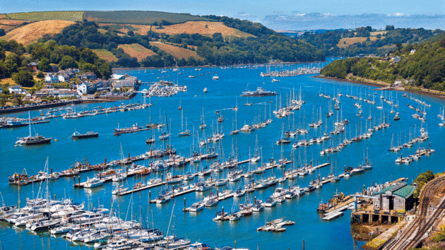 The River Dart is full of luxury yachts and boats showing the wealth of the historic town of Dartmouth