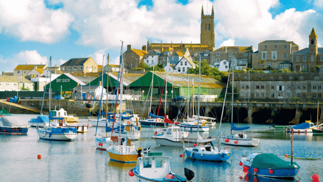 Penzance harbour, Cornwall on a summer evening with St Mary’s parish church in background