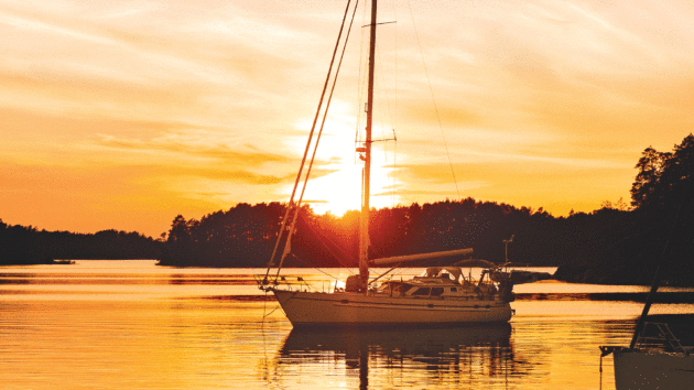 Sea Hayes sits silhouetted by a breathtaking sunset in Sweden