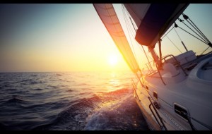 Yacht sailing at sunset