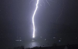 A moored yacht gets zapped by a bolt of lightning Pic: APEX News and Pictures