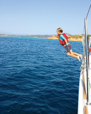 sardinia-charter-catamaran-lagoon-620-jumping-off-credit-helen-fretter