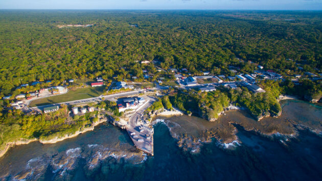 Aerial view of the landing wharf and Alofi township on Niue