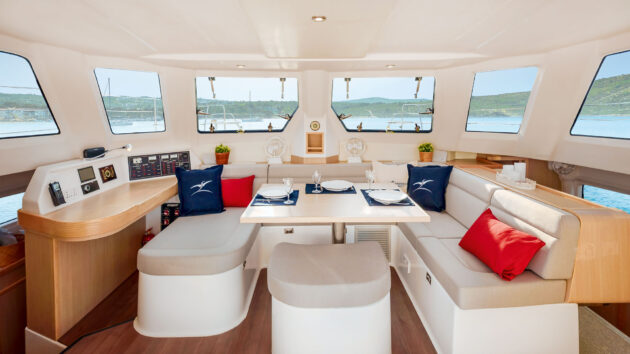 Fixed benches around a table that pivots and lowers.