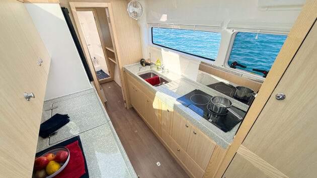 Large linear galley is in starboard ama passageway but still open and connected to the saloon.