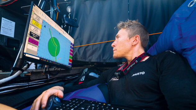 Will Harris at the nav station of the IMOCA Malizia in the 2023 iteration of The Ocean Race.