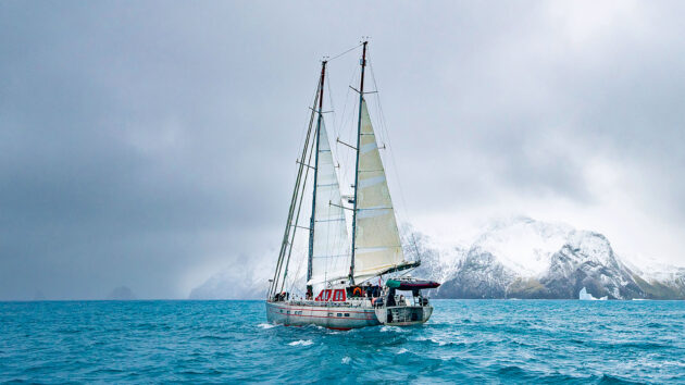 Vinson under reduced sail slides down the South Georgia coast, with williwaws an ever present risk