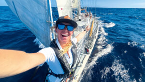 Person taking a selfie while smiling aboard a yacht