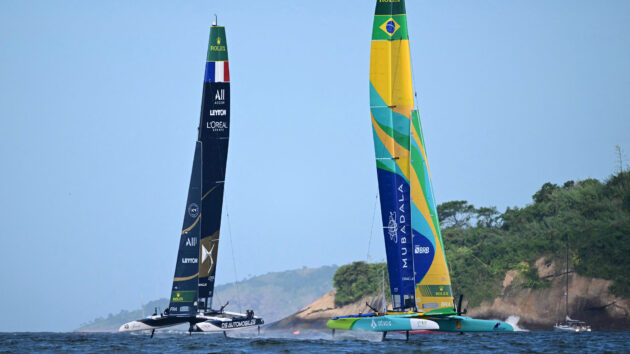 France's team (L) and Brazil's team competing in Guanabara Bay