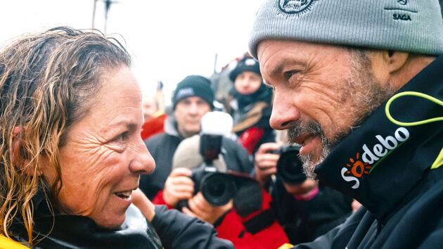 Jules Verne record holder Thomas Coville congratulates Alexia Barrier at the finish.