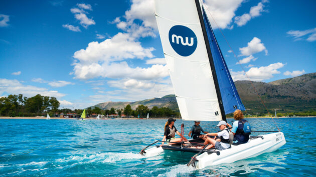 People sailing on a small catamaran