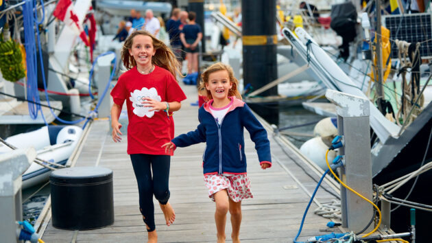 Two kids running on a pontoon