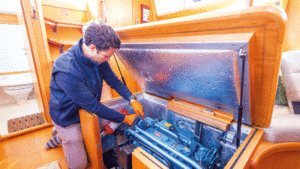 Someone checking a yacht engine