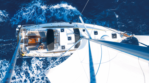 Aerial view of a yacht sailing from the mast