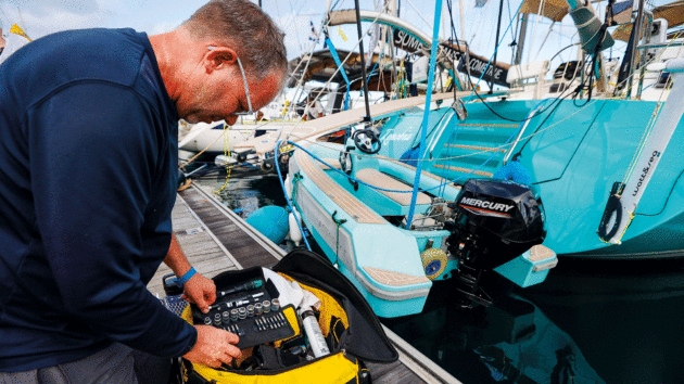 Someone on a pontoon with tools