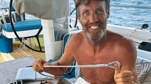Adam holding rope on the yacht