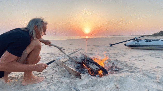 Sunset driftwood-fired barbecue on an idyllic, deserted West African white sand beach