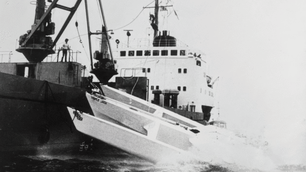 Triple Jack is towed across the 1981 TWOSTAR finish line in Newport, Rhode Island, by a freighter