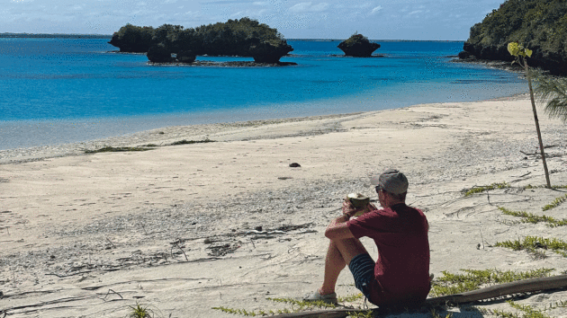 The captain enjoying a fresh coconut after a walk to the outer reef lagoon