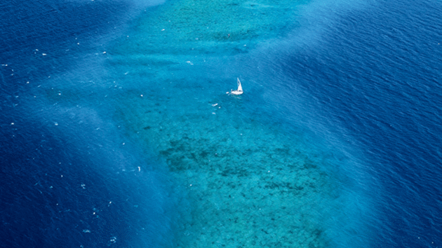 A yacht above a coral reef