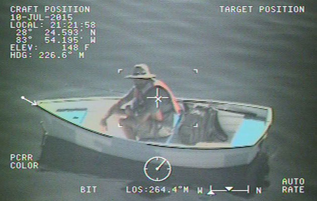 Man in wooden dinghy