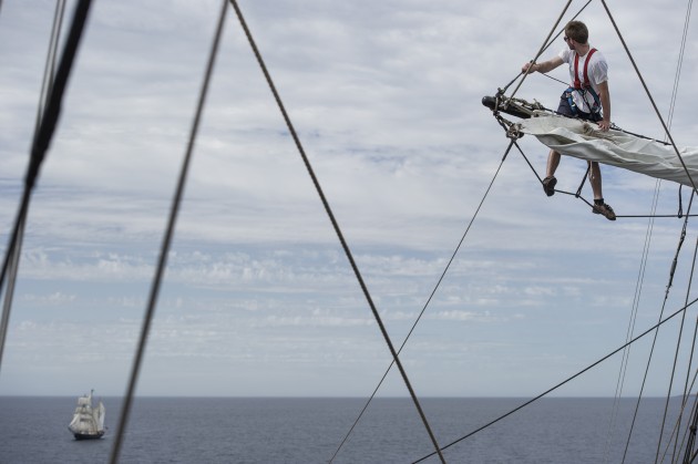 person on a boat mast