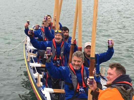 The Epic Row crew celebrate finishing a leg of their journey