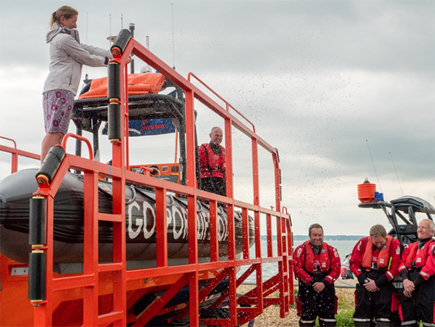 Dee Caffari sprays the new Gosport & Fareham Inshore Rescue Service lifeboat Joan Dora Fuller with champagne