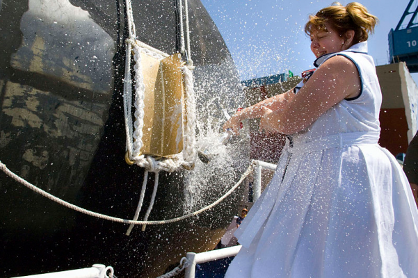 Debra Dunham, mother of late Cpl. Jason Dunham and ship's sponsor breaks a bottle of champagne across the bow of the Arleigh Burke-class guided-missile destroyer Jason Dunham (DDG 109) during the ship's christening ceremony at General Dynamics Bath Iron Works in Bath, Maine. Dunham posthumously received the nation's highest military honor, the Medal of Honor for his actions on April 14, 2004 in Karabilah, Iraq