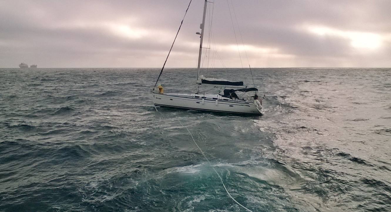 Lizard lifeboat tows the stricken yacht Blue Lagoon