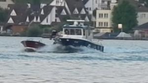 Swiss policeman leaps into an out of control speedboat in Lake Zurich