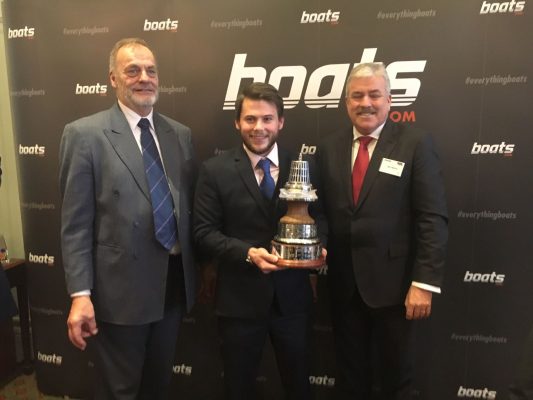 gavin reid poses with his yachtsman of the year award