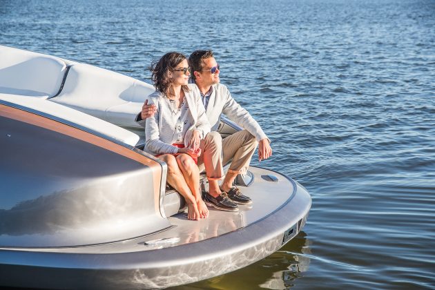 Couple sitting on the back of a motor yacht