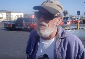 A man with a grey beard and baseball cap