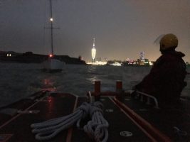 A lifeboat crew tows a yacht in Portsmouth Harbour