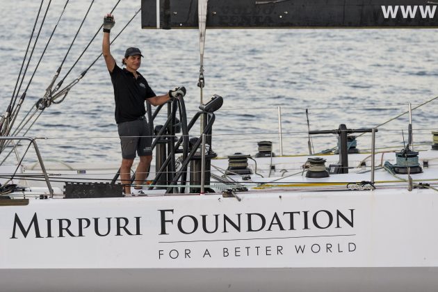 A skipper waves as he arrives in Barbados after an Atlantic crossing
