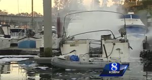 The smouldering remains of a boat at Santa Cruz Yacht Harbor