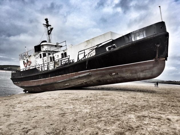 A RMAS tender on a beach in Cornwall