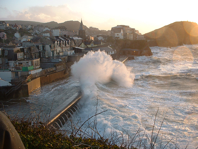 A large wave hits a beach in Devon