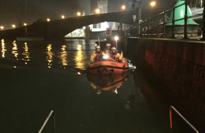 A lifeboat with men inside on the water at Conwy