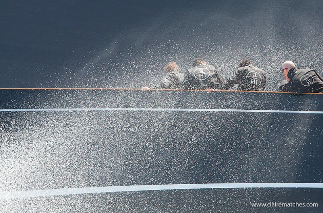 sailors being sprayed by the sea