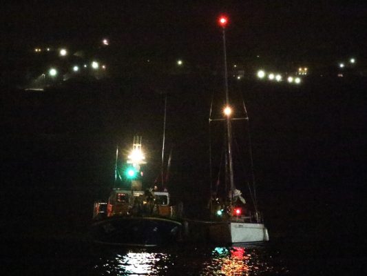 A yacht is escorted into harbout by Douglas RNLI