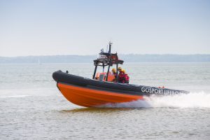 A lifeboat speeding along the water