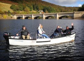 people on a boat waving