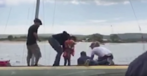 Men rescue children from a stricken yacht