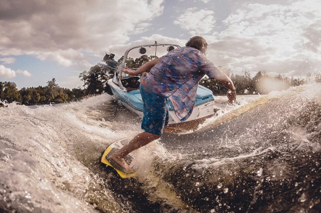 A man wakeboard behind a powerboat