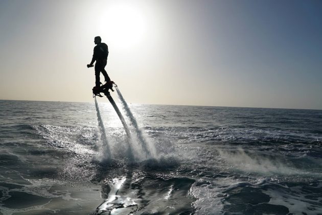 A man flies up into the air from the sea