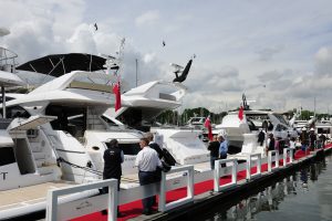 Visitors to the British Motor Yacht Show look at motor yachts