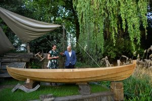 Duchess of Cornwall in a floral print dress tours a garden at the RHS Chelsea Flower Show