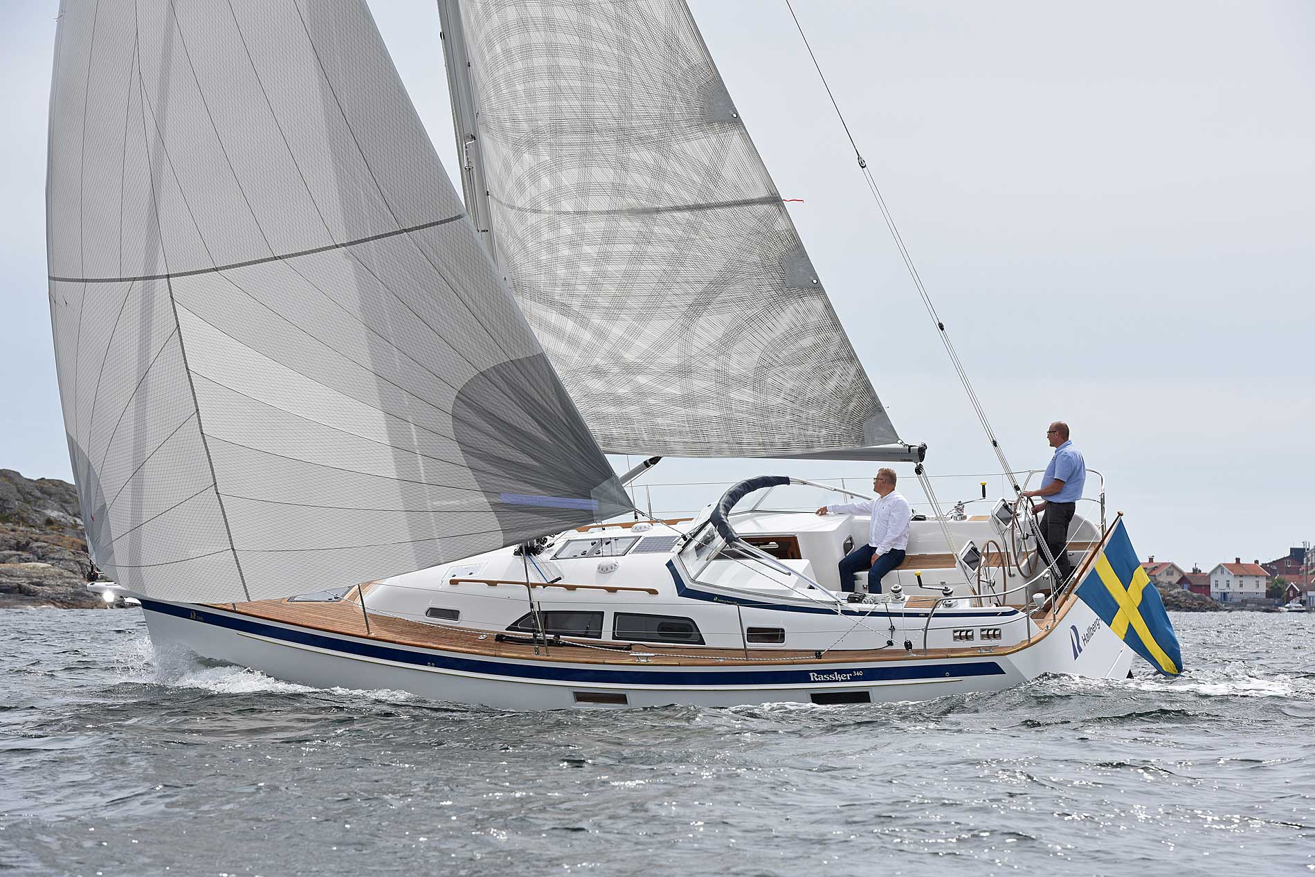 With white sails, the Hallberg-Rassy 340 on the water